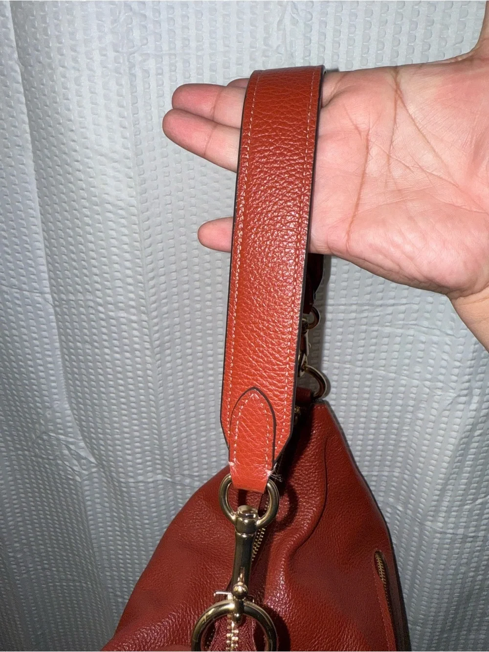 Coach Pennie Shoulder Bag features gold hardware and side suede pockets